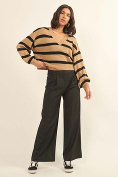 Striped knit sweater. Banded V neckline. Long bishop sleeves. Drop shoulder. Ribbed neckline, cuffs, and hem. Cropped length. Relaxed fit. 100% Acrylic. Imported. Designed in LA. Model wears size S. Striped Knit Sweater, Lesson Learned, Ribbed Neckline, V Neckline, Lessons Learned, Striped Knit, Cropped Sweater, Drop Shoulder, Knit Sweater