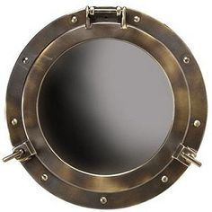 an antique brass porthole mirror with rivets