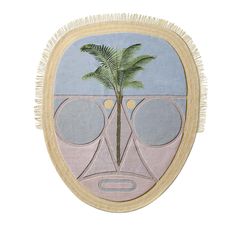 a round wall hanging with a palm tree and two circles in the middle, on a white background