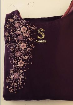 an embroidered purple shirt with flowers on it