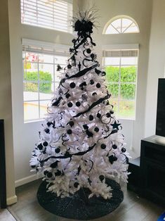 a white christmas tree with black and white decorations