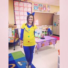 a girl in a yellow shirt and blue leggings is smiling at the camera