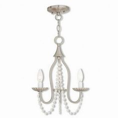 a white chandelier with three lights hanging from it's sides and pearls on the