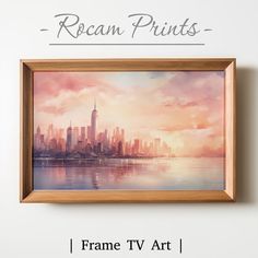 the frame tv art is hanging on the wall above it's water and cityscape