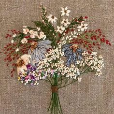 a bouquet of flowers on a piece of linen with some tiny white and red flowers