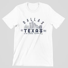 We are proud to showcase locations throughout Texas with our new city-specific design series! If you're from Dallas or you want to show your support for the city, we've got the perfect items for you. These tees are a great way to celebrate where you live, where you're from or where you want to be. Soft and light, with just the right amount of stretch Unisex cut is flattering for both men and women 100% Airlume combed and ring-spun cotton Designed & produced locally Graphic Crew Neck T-shirt For Urban Adventures, Urban Style Cotton T-shirt For Urban Adventures, Urban Short Sleeve T-shirt For Fan Merchandise, Urban Style Fan Merchandise T-shirt, Urban Pre-shrunk T-shirt For Fan Merchandise, Urban Style Tops With Screen Print, Graphic Tee T-shirt With Letter Print For Urban Adventures, Graphic Print T-shirt, Short Sleeve Cotton T-shirt For Urban Adventures