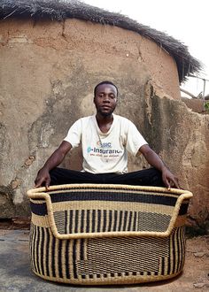 a man sitting on top of a woven basket