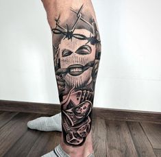 a man's leg with tattoos on it