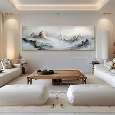 a living room filled with white couches and a coffee table in front of a painting