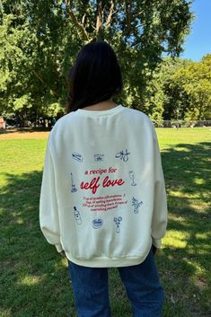 a woman standing in the grass wearing a sweatshirt that says, wedding for self love