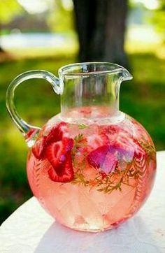 a pitcher filled with liquid sitting on top of a table