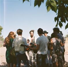 a group of people standing around each other