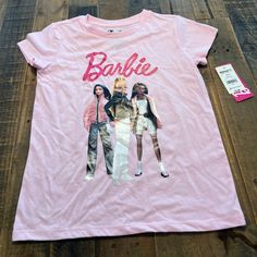 Barbie Short Sleeve Pink T Shirt New With Tags Attached Size 10/12 Large Kids Trendy Cotton T-shirt For Playwear, Casual Crew Neck T-shirt For Playwear, Summer Character Print Tops For Playwear, Pink Letter Print Tops For Playwear, Pink Short Sleeve Tops With Character Print, Short Sleeve Pink Tops With Character Print, Spring Crew Neck T-shirt For Play, Spring Playwear Crew Neck T-shirt, Spring Short Sleeve Shirt With Character Print