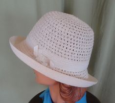 "This is a lovely vintage hat, that dates from the 90's. Label reads, \" San Diego Hat Co\". Made of polyester & paper straw. Tagged a size Women's O/S. It is an ivory mesh fedora with a white grosgrain ribbon hatband with chain accent. Brim can be worn up or down. Measures 22.5\" around the inside. The hat is in good, vintage condition. Shows no damage or wear. Chic!" White Classic Cloche Hat For Summer, Classic White Cloche Hat For Summer, Vintage Fedora For Beach In Spring, Vintage Beach Fedora For Spring, Vintage White Hat Band For Summer, White Cloche Straw Hat For The Beach, White Cloche Straw Hat For Beach, Retro White Hats For Summer, Vintage Fedora For Vacation And Spring