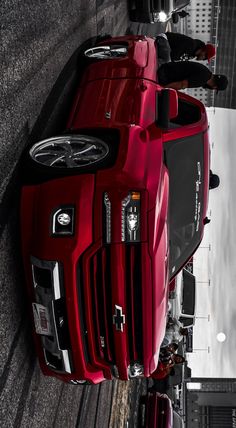 a red truck parked on the side of a road