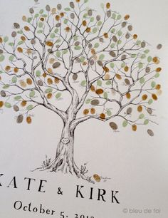 a wedding guest book with a tree drawn on the cover and leaves painted on it