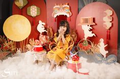 a woman sitting on top of a cloud covered floor