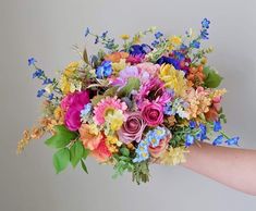 a person holding a bouquet of flowers in their hand