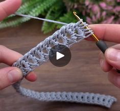 someone crocheting the end of a piece of yarn with two hands holding it