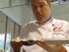 a man in a chef's uniform is holding a tray with food on it