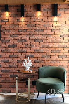 a chair and table in front of a brick wall