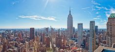 an aerial view of new york city with the empire building in the foreground and surrounding skyscrapers