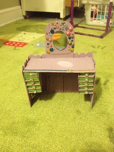 a toy desk and mirror on the floor