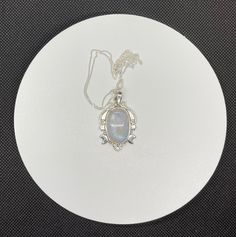 This enchanting pendant showcases a mesmerizing rainbow moonstone with an iridescent glow, set in a beautifully detailed sterling silver setting adorned with celestial stars and a crescent moon. Suspended on a 20" sterling silver chain, this piece captures the magic of the night sky, making it a perfect gift for dreamers and stargazers. This pendant is approximately 1 7/8" long and 1" wide. (not including the bail) Known for its soothing energy and ability to restore balance, the rainbow moonsto Celestial Stars, Rainbow Moonstone Necklace, Rainbow Moonstone Pendant, Moonstone Necklace, Moonstone Pendant, Pendant Set, Sterling Silver Chain, The Rainbow, Crescent Moon