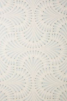 a blue and white wallpaper with small dots on it