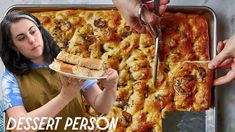 a woman holding a piece of pizza in front of a pan with the words desert person on it