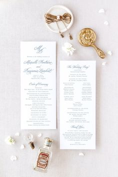 the wedding ceremony program is displayed next to a bottle of wine and a gold spoon