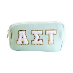 a mint green cosmetic bag with the letters delta on it and sequins in gold