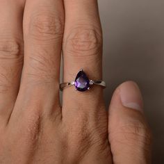 This is a gorgeous handmade creation. Its beauty is its simplicity & Elegance. The 6*9 mm pear shape faceted natural amethyst is crafted in solid sterling silver and with rhodium plated. All item is sent in a beautiful gift box If you have any idea of design your ring,pls contact me directly. You can realize more lovely stuff clicking the link https://www.etsy.com/shop/knightjewelry?refshopsection_shophome_leftnav Please leave the correct address and you phone number for delivering successfu Teardrop Birthstone Jewelry For Promise Ring, Teardrop Diamond Ring With Gemstone As Gift, Teardrop Diamond Ring With Gemstone For Gifts, Teardrop Solitaire Jewelry For Anniversary, Formal Teardrop Birthstone Rings, Minimalist Amethyst Wedding Ring, Fine Jewelry Teardrop Crystal Ring For Anniversary, Teardrop Amethyst Ring For Anniversary, Teardrop Crystal Ring For Anniversary