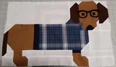 a paper cut out of a dog wearing glasses