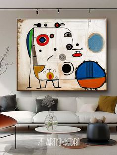 a living room filled with furniture and a painting on the wall above it's coffee table