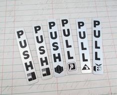 some stickers are laying on top of a piece of paper that says push pull