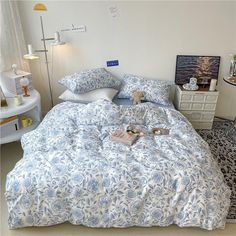 a bed with blue and white comforters in a bedroom