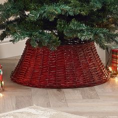 a christmas tree in a basket on the floor