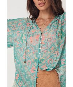 The versatile Spell Farrah Aqua Blouse has so much to offer with its shell button down front, smocking, adjustable tie front and billowy boho sleeves. This super soft new cotton staple is sure to be worn on repeat. Style with your favorite jeans, shorts or skirts for an effortless cool-girl look. - Unlined, semi sheer design- Soft cotton hand feel- Multiple ways to style - Responsibly created in our much love preferred fibres blend of organic cotton- Shell button down front for multiple ways to Vacation Blouse With Pockets, Luxury Bohemian Blouse Piece In Georgette, Luxury Bohemian Cotton Silk Blouse Piece, Luxury Bohemian Tops With Buttons, Luxury Bohemian Unstitched Blouse, High Waisted Flares, Kimono Sleeve, A Button, On Repeat