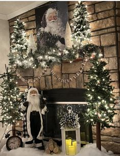 a mantel decorated with christmas trees and lights in front of a santa clause on the mantle