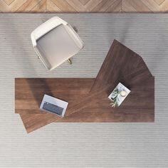 an overhead view of a desk with a laptop, keyboard and mouse pad on it