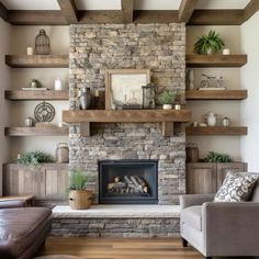 a living room filled with furniture and a fire place in front of a stone fireplace