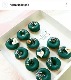 there are twelve donuts with green icing and sprinkles