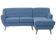 a blue couch sitting on top of a white floor next to a wooden leg chair