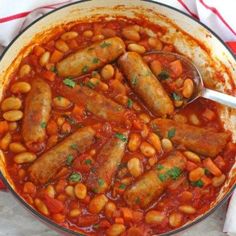 a pot filled with beans and sausage