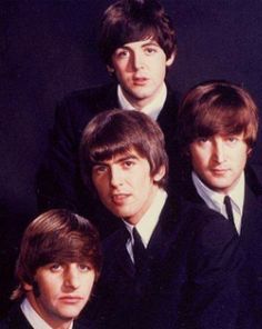 the beatles are posing for a photo together