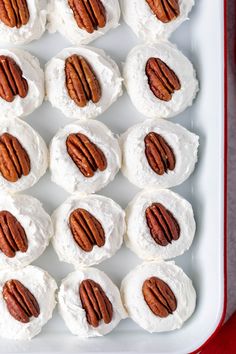 there are many pecans on top of the marshmallows in this tray