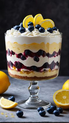 a dessert with lemons, blueberries and whipped cream in it on a table