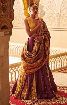 Editor's Note Purple Godet Lehenga Set Fabric: Lampi, Chanderi Color: Purple Care: Dry Clean Only About the Designer Itrh makes a high-end luxury Indian ethnic wear made using exquisite and endangered age-old crafts such as kalamkari, madhubani, chikankari, zardozi, and gota weaving. The focus of the house is to cherish the beauty of handcrafted luxury designer wear. Brocade Anarkali Pre-draped Saree With Cutdana, Unstitched Brocade Pre-draped Saree For Wedding, Brocade Pre-draped Saree For Wedding And Eid, Wedding Brocade Pre-draped Saree For Eid, Wedding Eid Brocade Pre-draped Saree, Brocade Pre-draped Saree For Reception, Reception Brocade Pre-draped Saree With Zari Work, Brocade Pre-draped Saree With Dupatta For Wedding, Festival Pre-draped Brocade Saree With Resham Embroidery