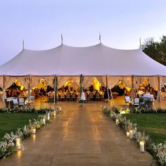 a large tent set up with candles and flowers